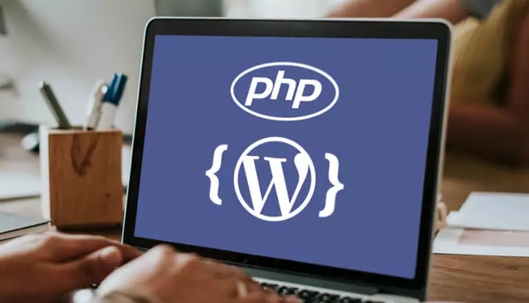 PHP and WordPress logos on a laptop